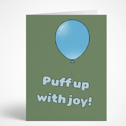 Зелена поздравителна картичка на английски език с илюстрация на голям син балон и закачлив надпис Puff up with joy!, изписан с пухкави букви като облаци.